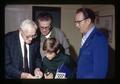 John Fowler showing 1883 coin to Tom Driscoll Jr. and Tom Driscoll Sr., Corvallis Coin Club, Corvallis, Oregon, circa 1972