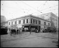 Site of Holtz Building at N. W. Fifth & Washington, Portland. Dental offices in wood bldg on corner. Posters over windows…