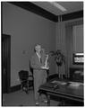 President Strand holding a model of the Lady of the Fountain statue