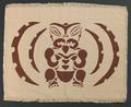 Placemats (set of two) of muted pink, rib woven cotton with brown block print of a stylized Tiki God figure