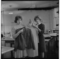 Home Economics students displaying garments in a clothing and textiles research lab, February 1964