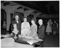 Guests at a president's reception in the Memorial Union perusing historic maps