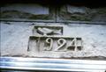 Date and carved dove above doorway