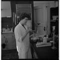A student working with laboratory equipment in a Home Economics research lab, February 1964