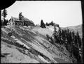 Crater Lake Lodge on rim of crater. Steep crater wall in foreground.