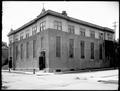 Unidentified Catholic church, Portland. Two men standing in open doorway on corner of building.