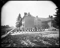 Thompson School, Portland, with students in even rows on sidewalk in front of building.