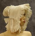 Sunbonnet of white cotton with trim of eyelet embroidered ruffle