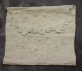 Fabric for a purse of white linen with eyelet embroidery of vines with flowers