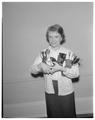 Beverly Burgoyne, Senior in Education, holding her speech contest trophies, 1960