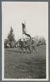 Cadet color guard marching on parade field, circa 1920