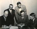 James Bagan (left), E. Shelton Hill (2nd from left), Edwin C. Berry (standing at center) and Peter Gantenbein (at right)