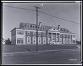 Front view, Albertina Kerr Orphanage, East 22nd St., Portland. Group of nurses standing on porch, power pole in foreground.