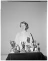 Beverly Burgoyne, Senior in Education, with her speech contest trophies, 1960