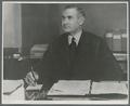 William Jasper Kerr seated at desk, circa 1930
