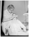 Murial Woodring practicing dentistry in a Home Economics research lab, 1957