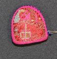 Thimble (Kolmu) of fabric covered over layered paper trimmed along the edges with fuchsia yarns