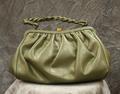 Purse-style handbag of soft olive green leather with a handle of twisted olive leather cord
