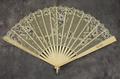 Folding fan of carved ivory with white silk mesh
