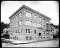 Hermenia Apartment building at 10th and Hall, Portland. Houses in background.