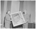 Dean Miriam Scholl and President Strand displaying a painting purchased by the OSC Foundation for the home management house, August 1957