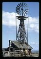 Dean Frischknecht and Reub Long by windmill at Harrison Ranch, near Fort Rock, Oregon, circa 1972