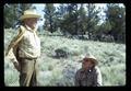 Reub Long and Dean Frischknecht examining range grass in Devils Garden, Lake County, Oregon, circa 1972