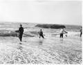 Men with nets standing in surf