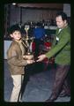 Elias Guzman and son holding Junior Best in Show trophy, Mid Valley Coin Club meeting, Corvallis, Oregon, 1971