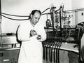 Professor Harold J. Evans injects bacterial extract into a tightly sealed, oxygen-free test tube, ca. 1972.