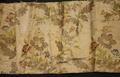 Textile fragment of ecru brocade with stemmed flowers with large leaves