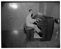 Tom Roberts playing the organ, October 22, 1953