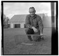 Forest mammologist Ed Hooven posing with a rodent trap