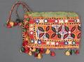 Pouch of red fine woven cotton or linen embroidered in a chain stitch in soft floral-like motifs