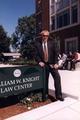 Phil Knight standing next to the sign for the William W. Knight Law Center