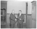 President Jensen presenting a certificate to an unidentified individual