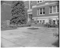 Flower garden and benches on south side of Home Economics Building, May 1959