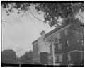 Sue Schwind, Home Economics freshman, poses with the new campus street signs, Fall 1953