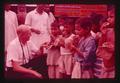 Jim Howard with kids eating chapatis, India, 1979