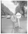 Earl Heckert posing on campus next to a stop sign.