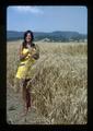 Woman standing in new wheat selections, Oregon State University, Oregon, 1975