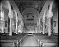 Interior of St. Patrick's Cathedral, looking toward altar. Pews in foreground.