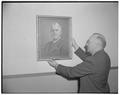 Fred O. McMillan, head of electrical engineering, hangs portrait of R. H. Dearborn, former head of Electrical Engineering and later dean of engineering, at dedication of Dearborn Hall, May 1949