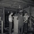 Workers Standing Next to Burlap Hop Bale