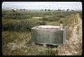 Large wooden box in middle of field, circa 1966