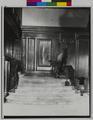 Stairway in Benson Hotel, Portland, with stuffed elk and painting of Multnomah Falls on landing. (recto)