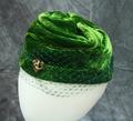 Toque-style hat of bright green silk velvet with folding to add design