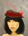 Capulet hat of iridescent feathers and red spotted feathers