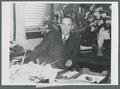August L. Strand seated at desk, circa 1945