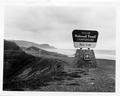 Rock Creek Campground sign with road and ocean in background